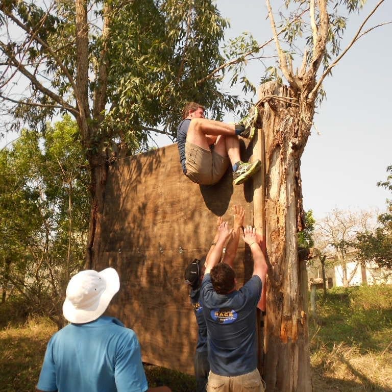 Man climbing wooden structure