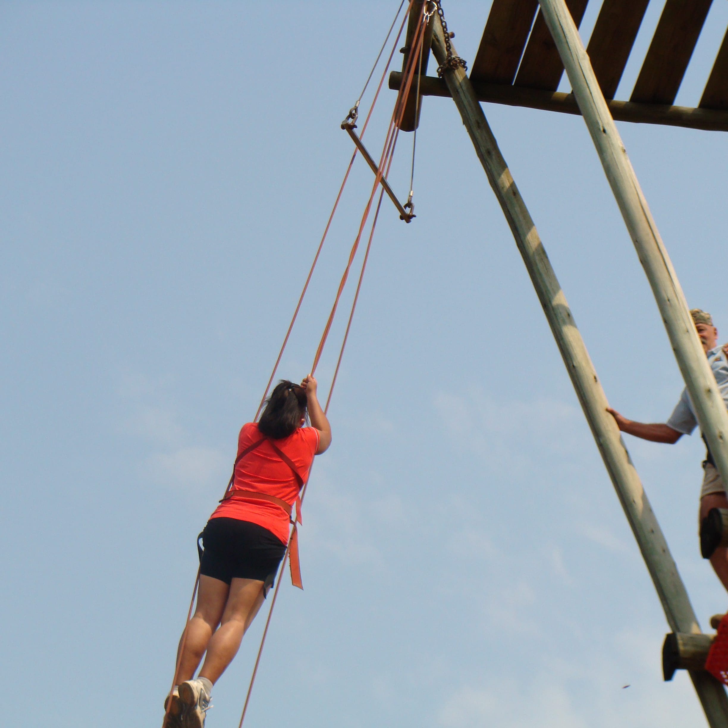 Woman hanging on harness