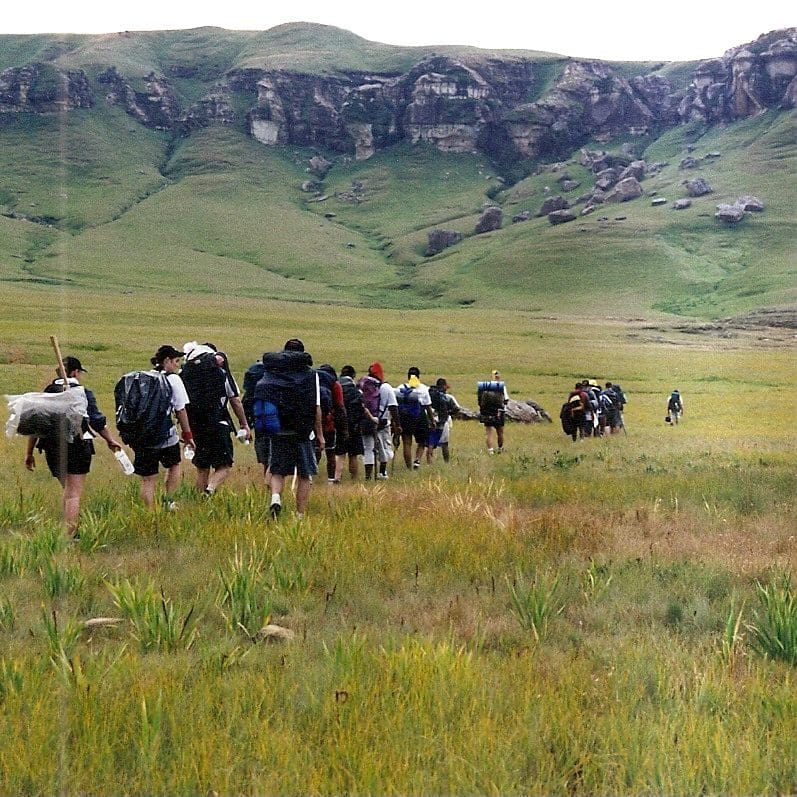 People hiking in field