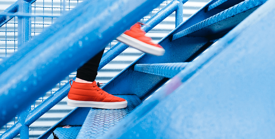 Feet climbing steps to reaching goals