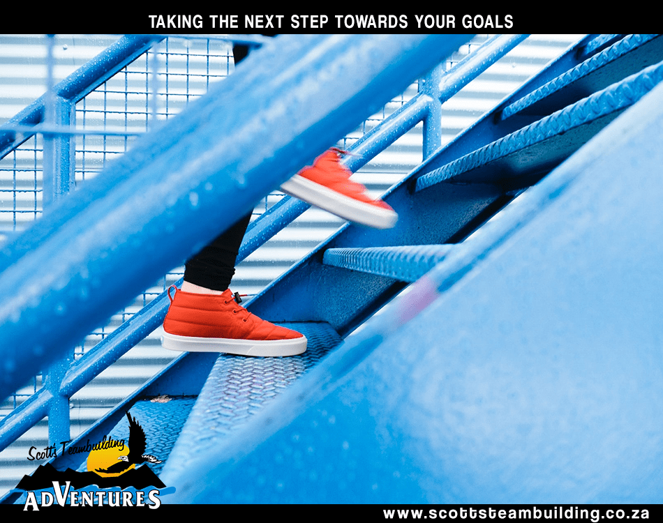 Feet climbing steps to reaching goals